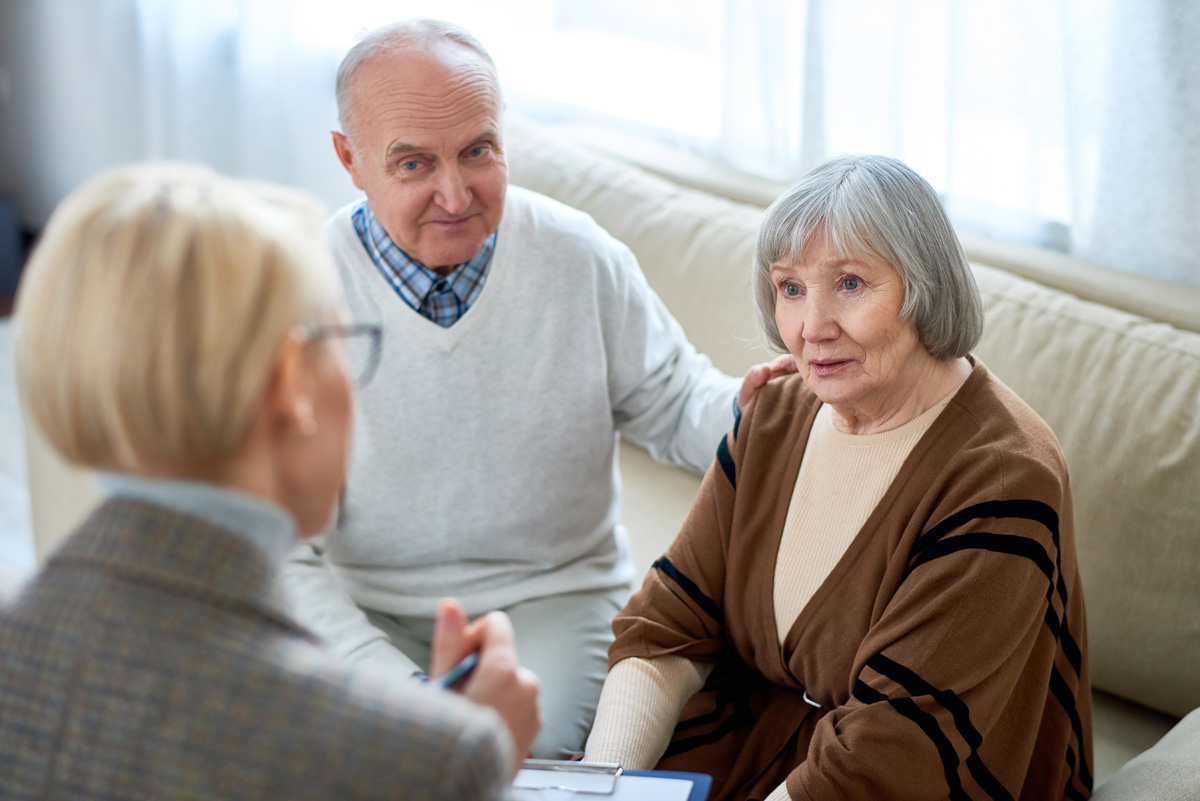 Anonymous therapist having meeting with elderly patients in nurs