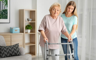 Young woman and her elderly grandmother with walking frame at ho